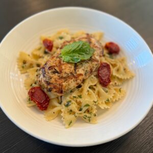 “Grilled Tuscan Chicken” - Marinated grilled Chicken breast seasoned with garlic, herbs, and Italian spices served over Herbed Farfalle Pasta and Sun Dried Tomatoes.